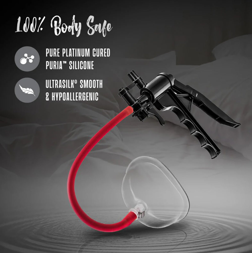 A black pump with a red tube connected to a clear silicone cup.