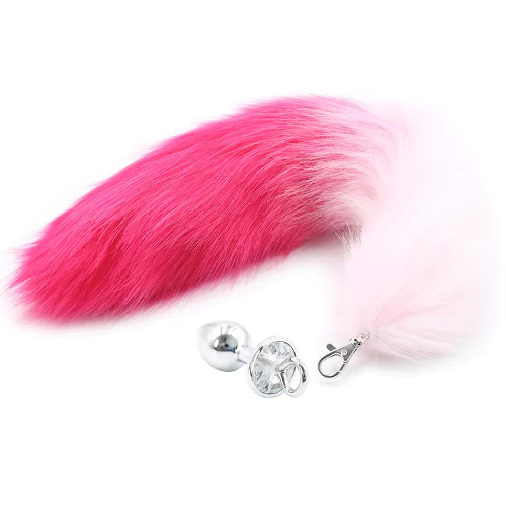 A pink and white faux fox tail anal plug with a silver base.
