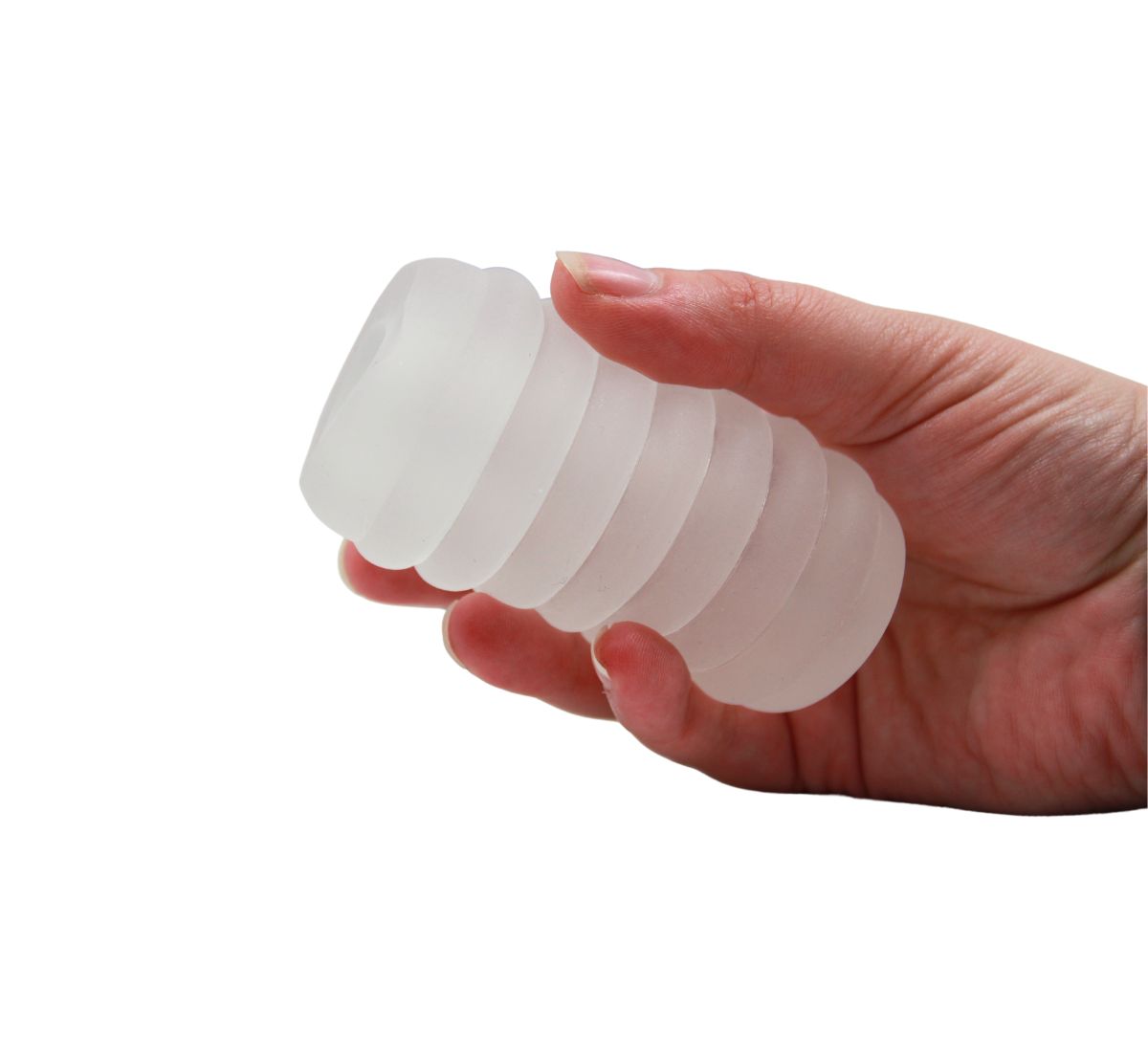 A frosted white ribbed masturbator held in a hand.