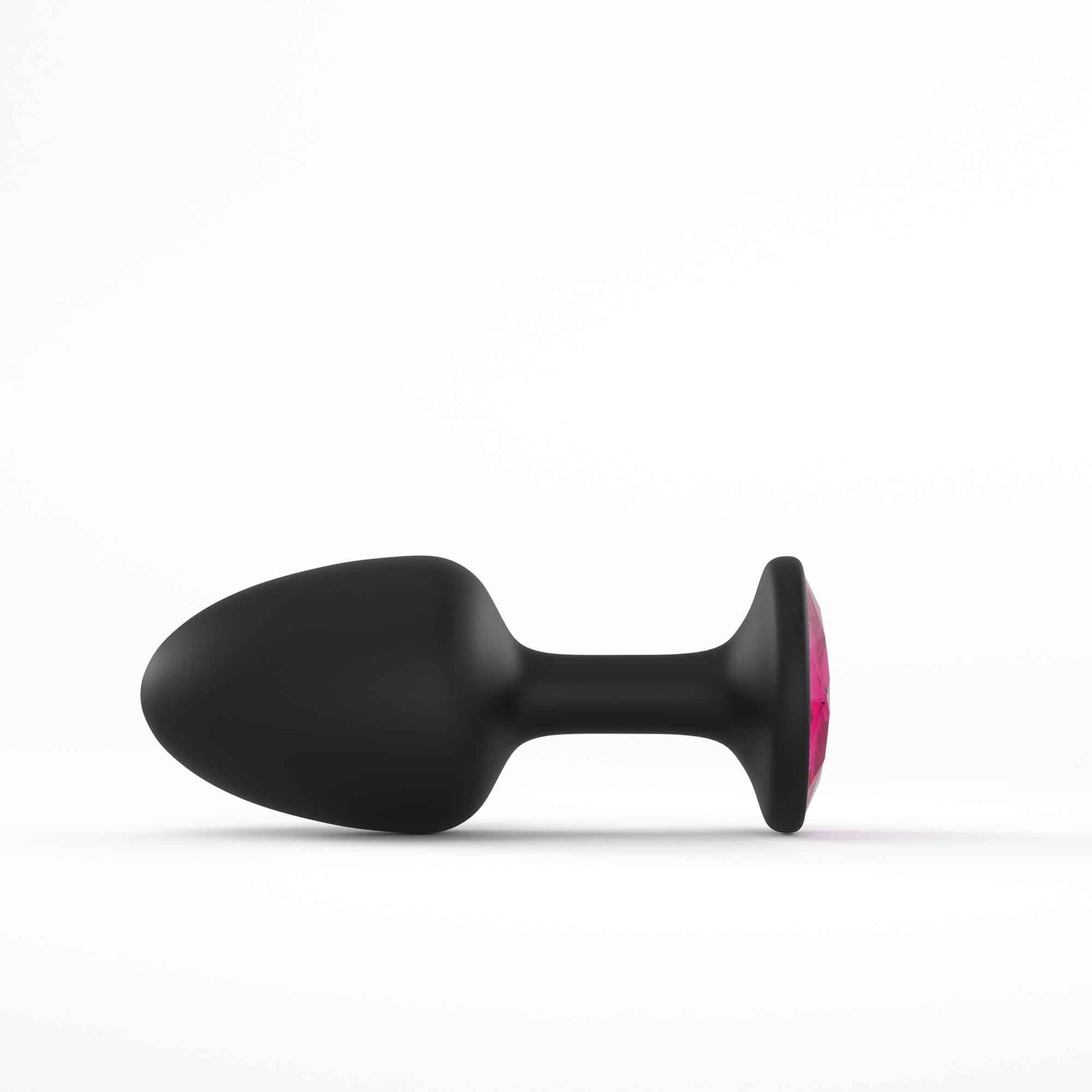 Black anal plug with a pink gem accent.