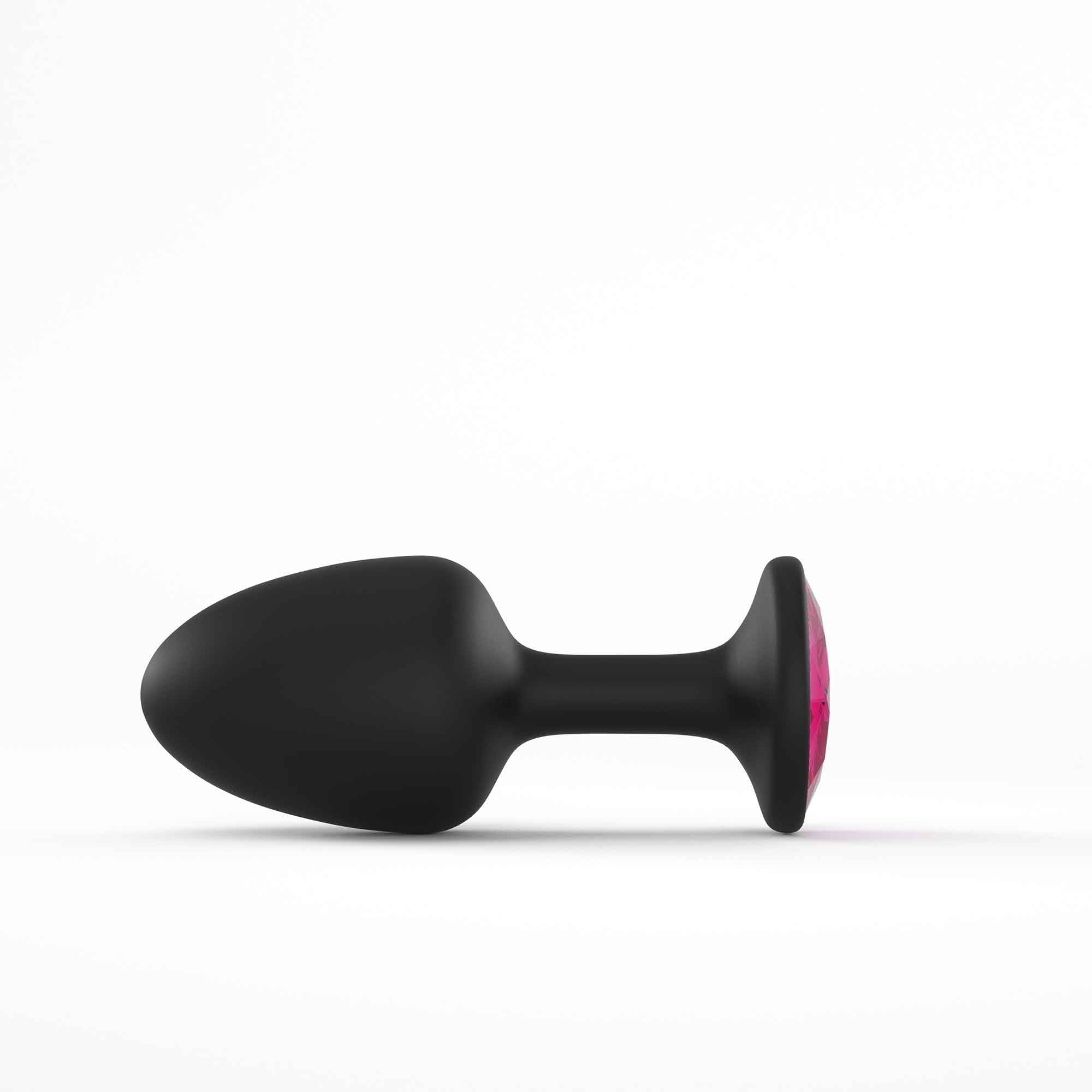 Black anal plug with a pink gem accent.