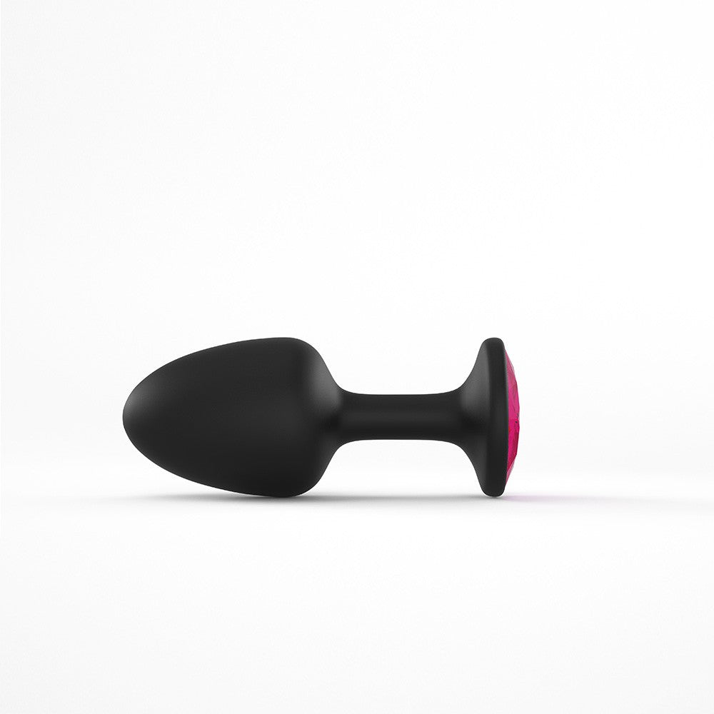 Black anal plug with a pink gemstone accent.