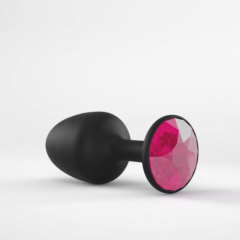 Black anal plug with a large faceted ruby gem.