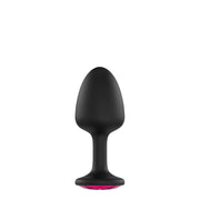 Black anal plug with a flared base featuring a faceted pink gem.