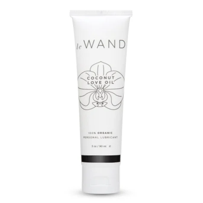 A white tube of Le Wand Coconut Love Oil personal lubricant with an orchid design.