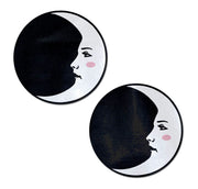Two round nipple pasties featuring a black crescent moon with a white face.