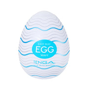 A white Tenga egg-shaped masturbator with blue and silver wavy lines and text.