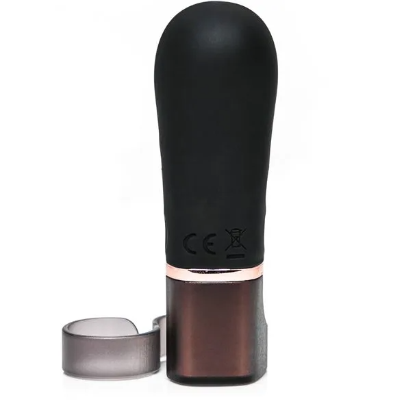 A black finger vibrator with a rose gold band and a translucent ring accessory.