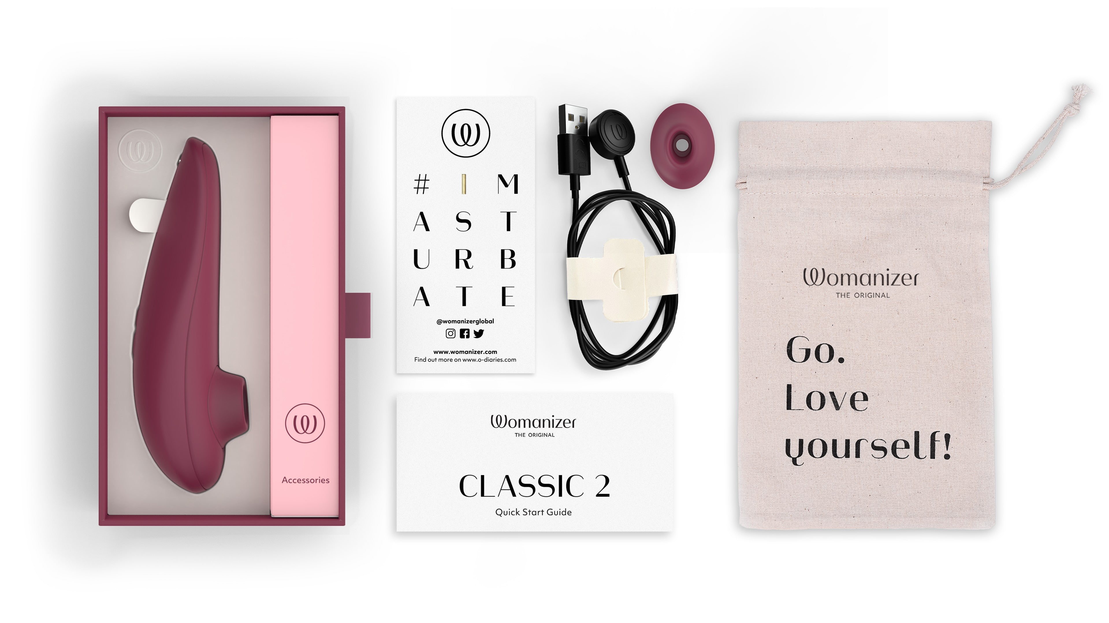 Womanizer Classic 2 clitoral stimulator in bordeaux with accessories.