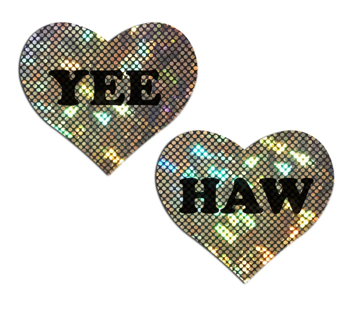 Two heart-shaped nipple pasties with "YEE" and "HAW" in black text on gold glitter.