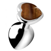 Silver anal plug with a heart-shaped tiger's eye gemstone.