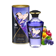 Shunga Exotic Fruits warming massage oil in a bottle with fruit and a tube.