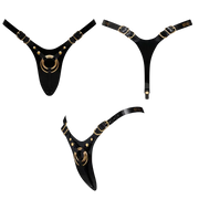Glossy black leatherette strap-on harness with gold hardware.