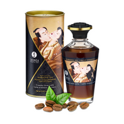 Shunga Creamy Love Latte edible warming massage oil in a bottle and tube with coffee beans.