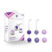 Silicone Kegel training kit with purple and pink weights and a box.