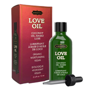 Kama Sutra Love Oil, organic coconut oil-based lubricant in a green bottle with a dropper.