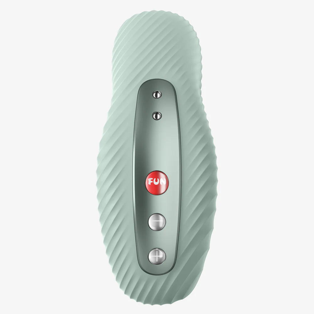 A light green external massager with a textured surface and control buttons.
