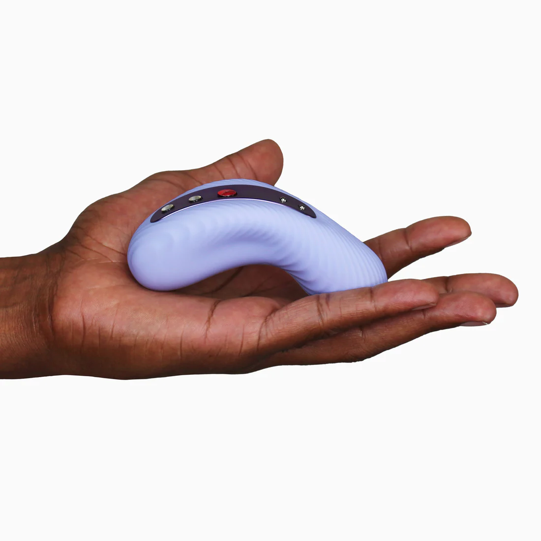 A purple vibrating external massager with buttons rests in an open palm.