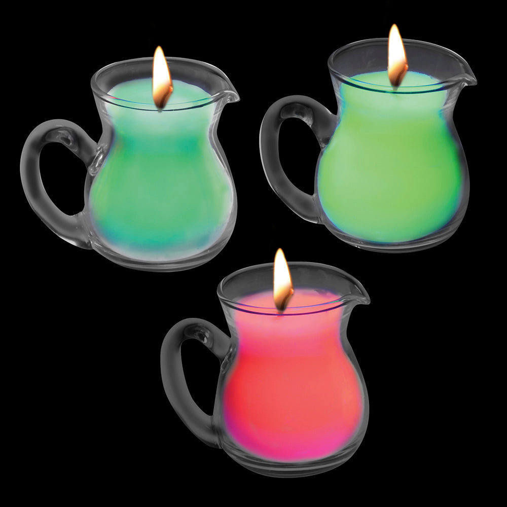 Three glass pitcher-shaped candles with neon wax in red and green.