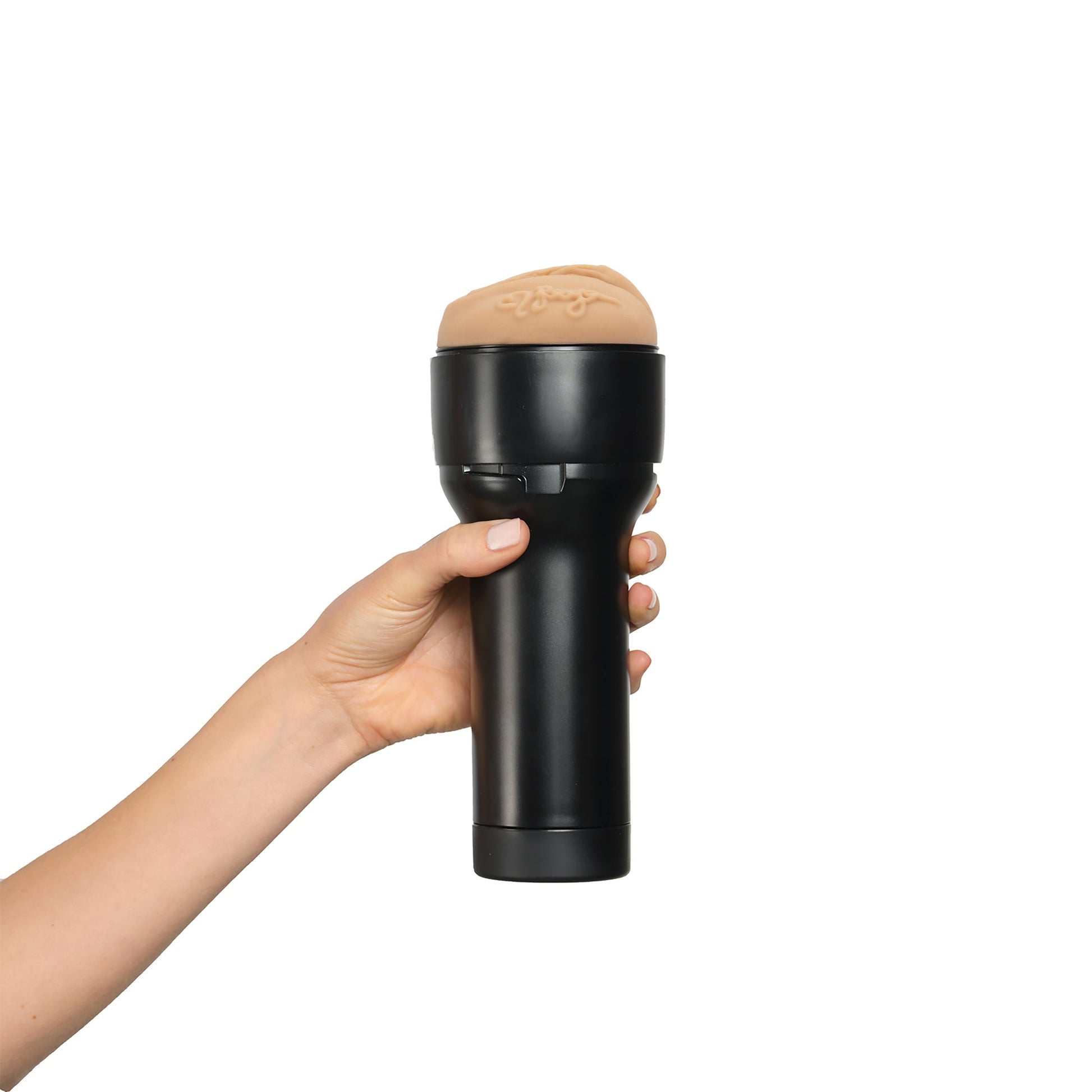 A hand holds a black masturbator sleeve with a realistic flesh-toned opening.