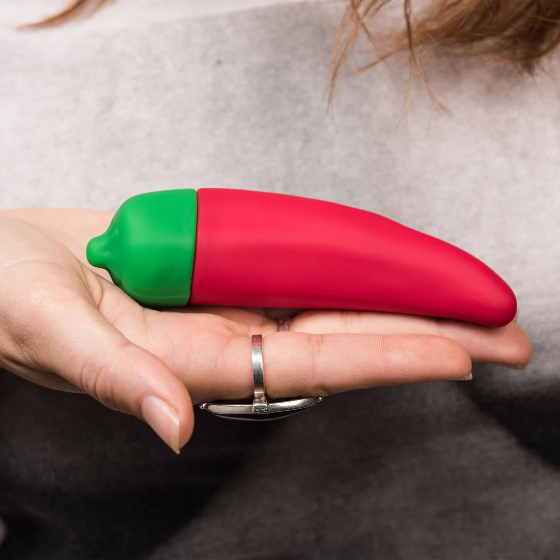 A red chili pepper shaped vibrator with a green tip.