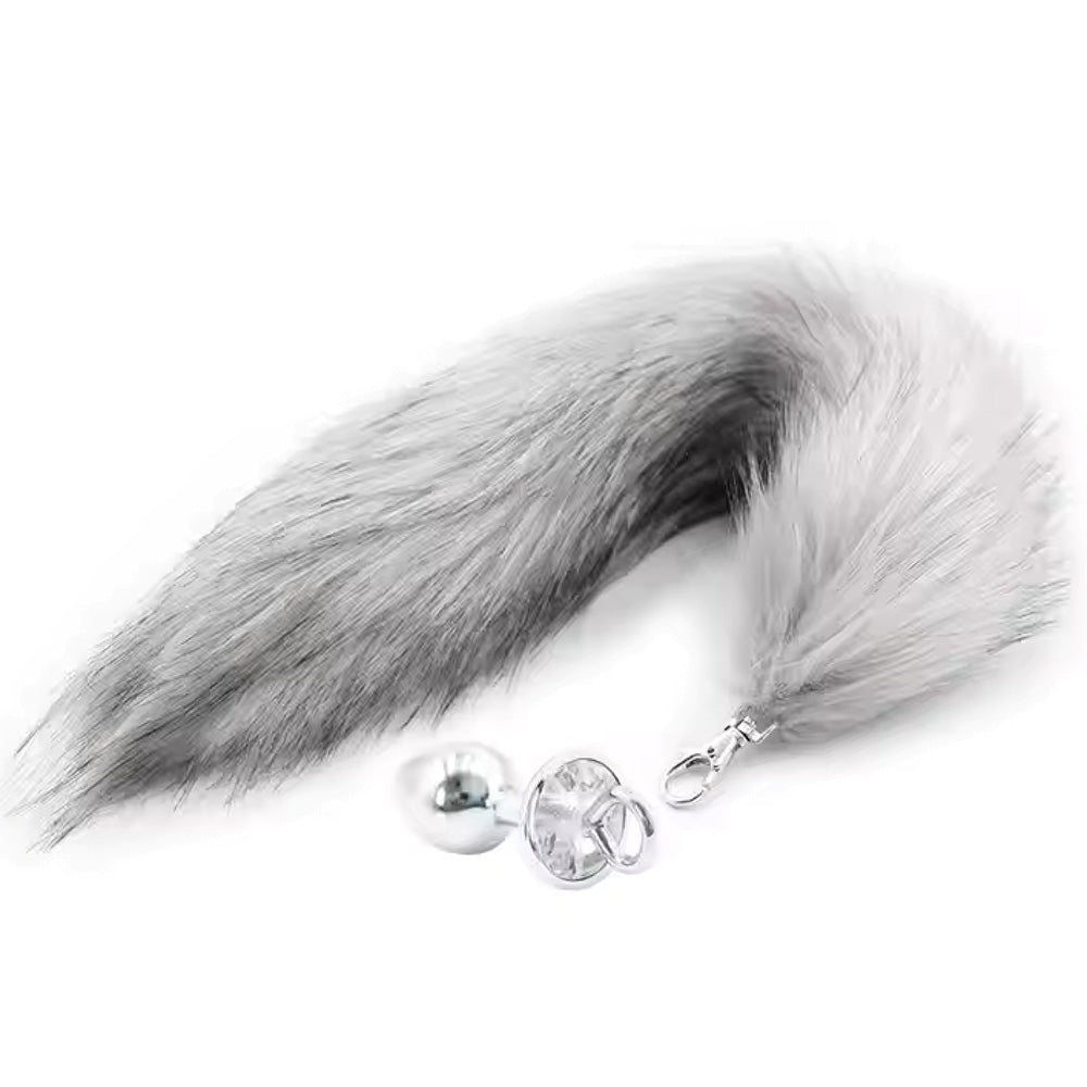 Grey faux fur tail with a silver anal plug.