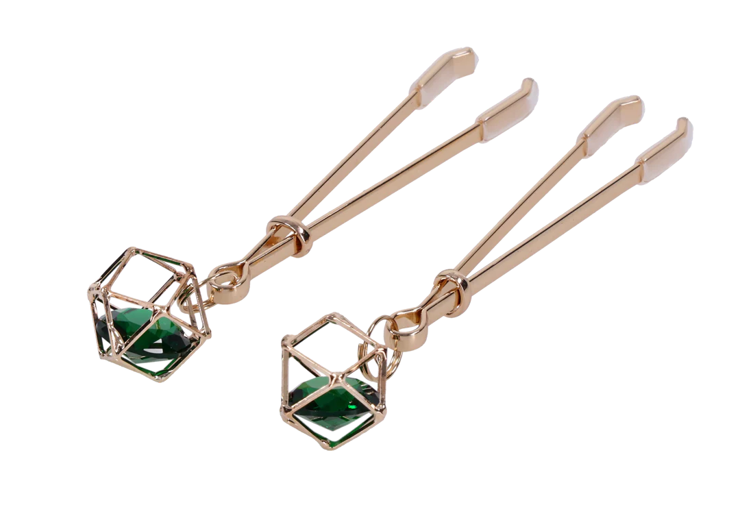 Gold nipple clips with green crystal accents and adjustable tension.