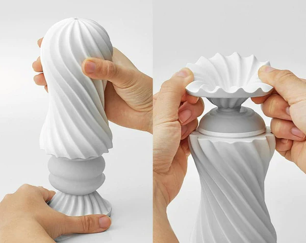 A white, ribbed, reusable masturbation sleeve being assembled.