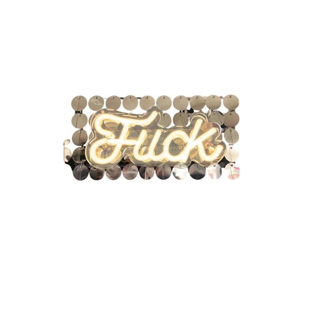 Neon sign spelling "Fuck" with a sequin background.