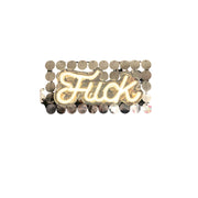 Neon sign spelling "Fuck" with a sequin background.