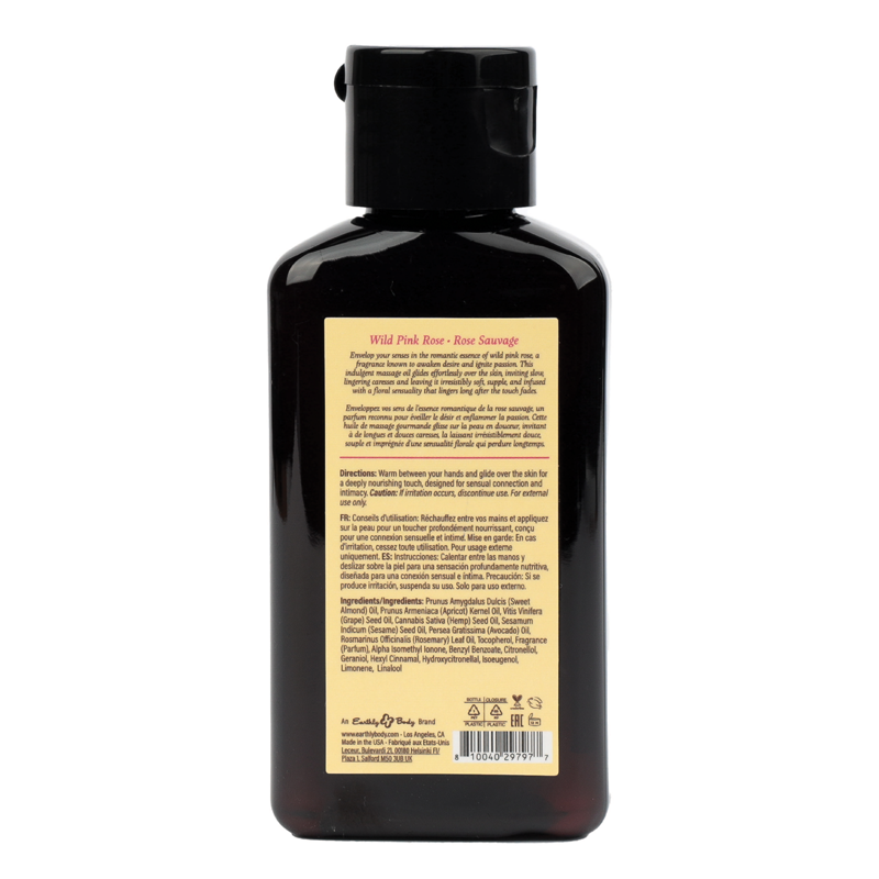 Wild Pink Rose massage oil in a dark bottle with a yellow label.