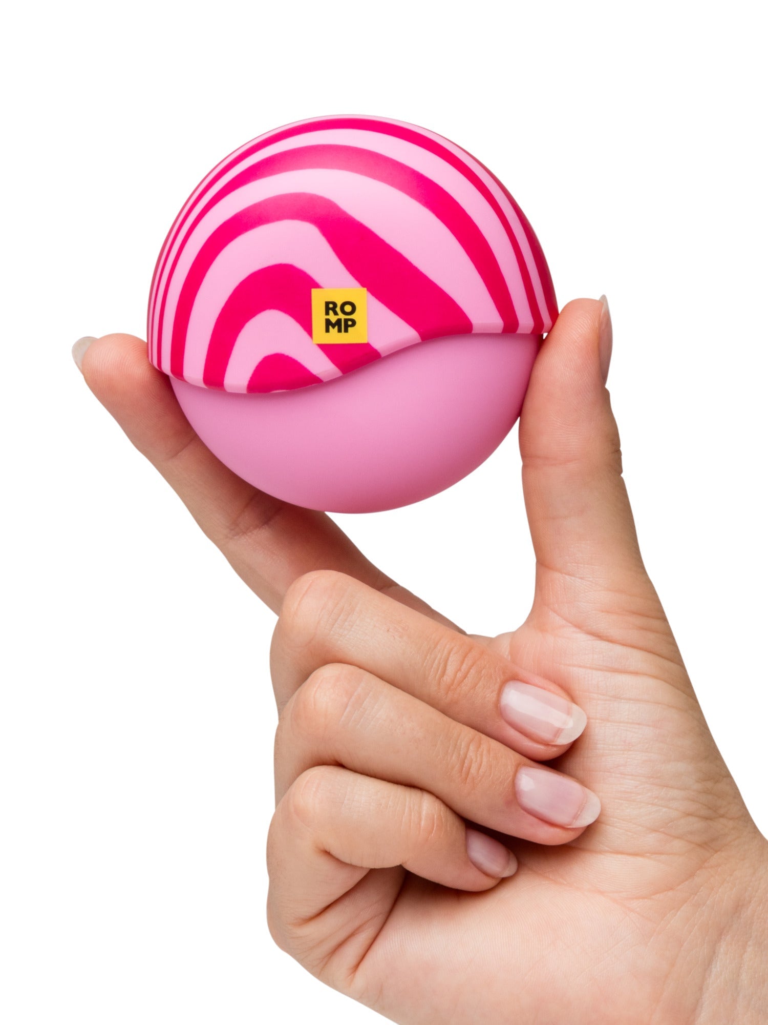 A pink spherical toy with pink stripes is held by a hand.