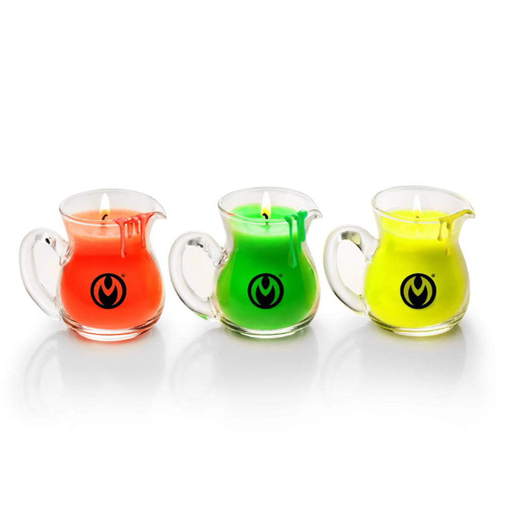 Three glass pitcher-shaped candles in neon red, green, and yellow.