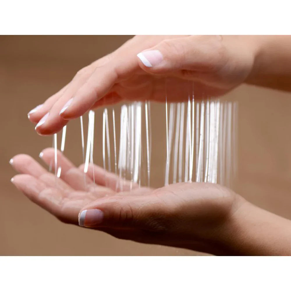 Hands holding clear gel strands between them.