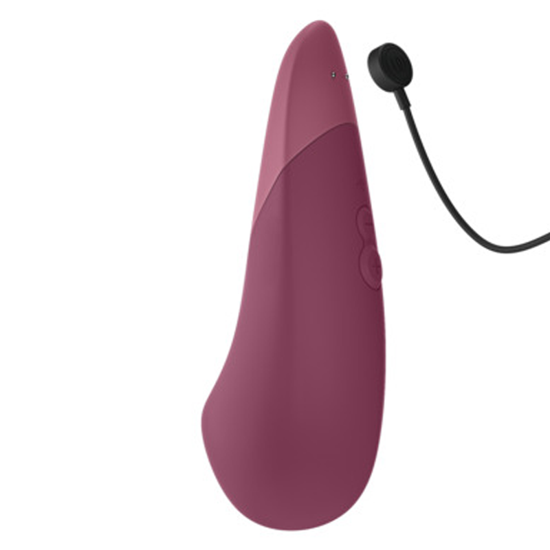 A dusky pink clitoral vibrator with a charging cable.