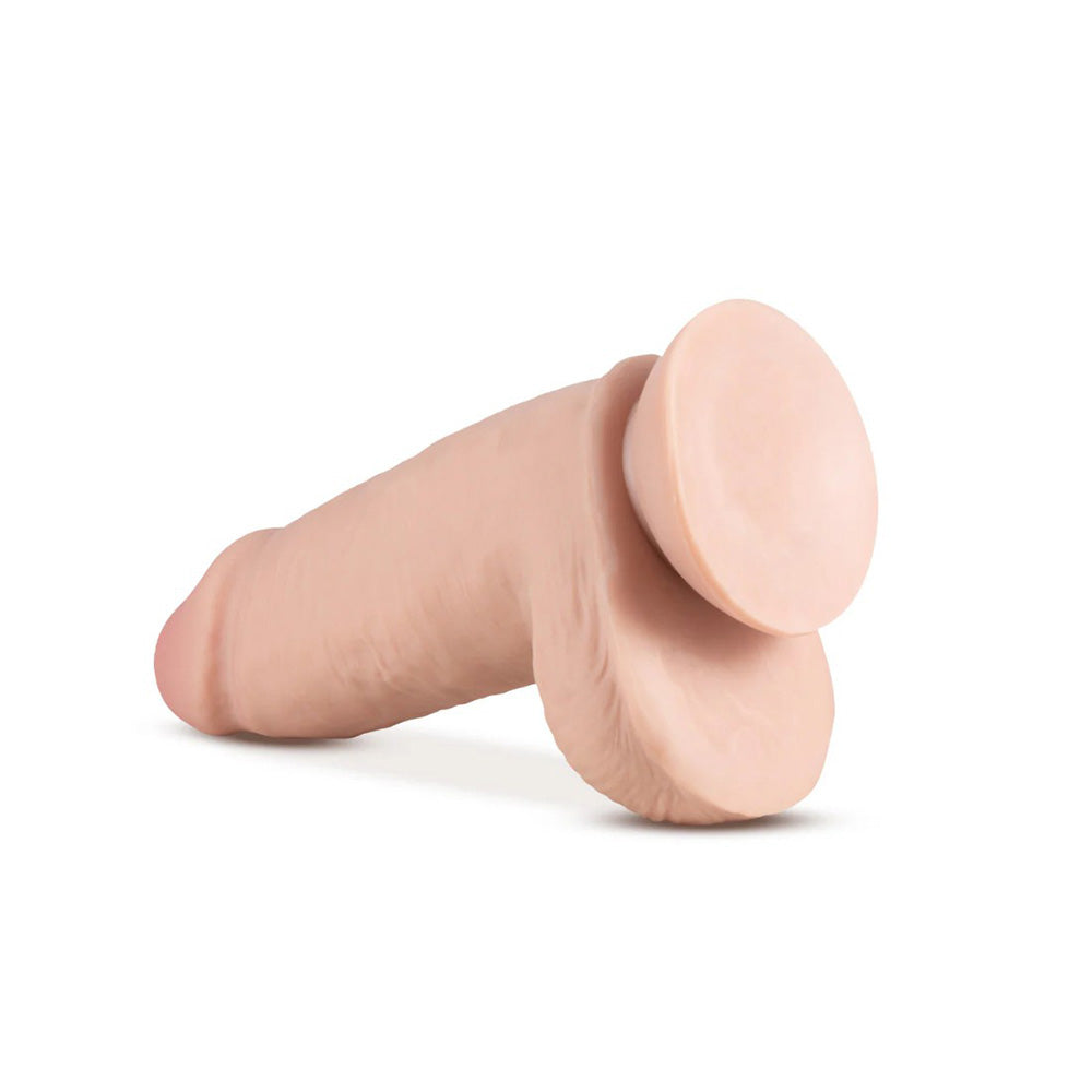 A 10-inch dual density dildo with thick shaft, suction cup base, and realistic flesh tone.