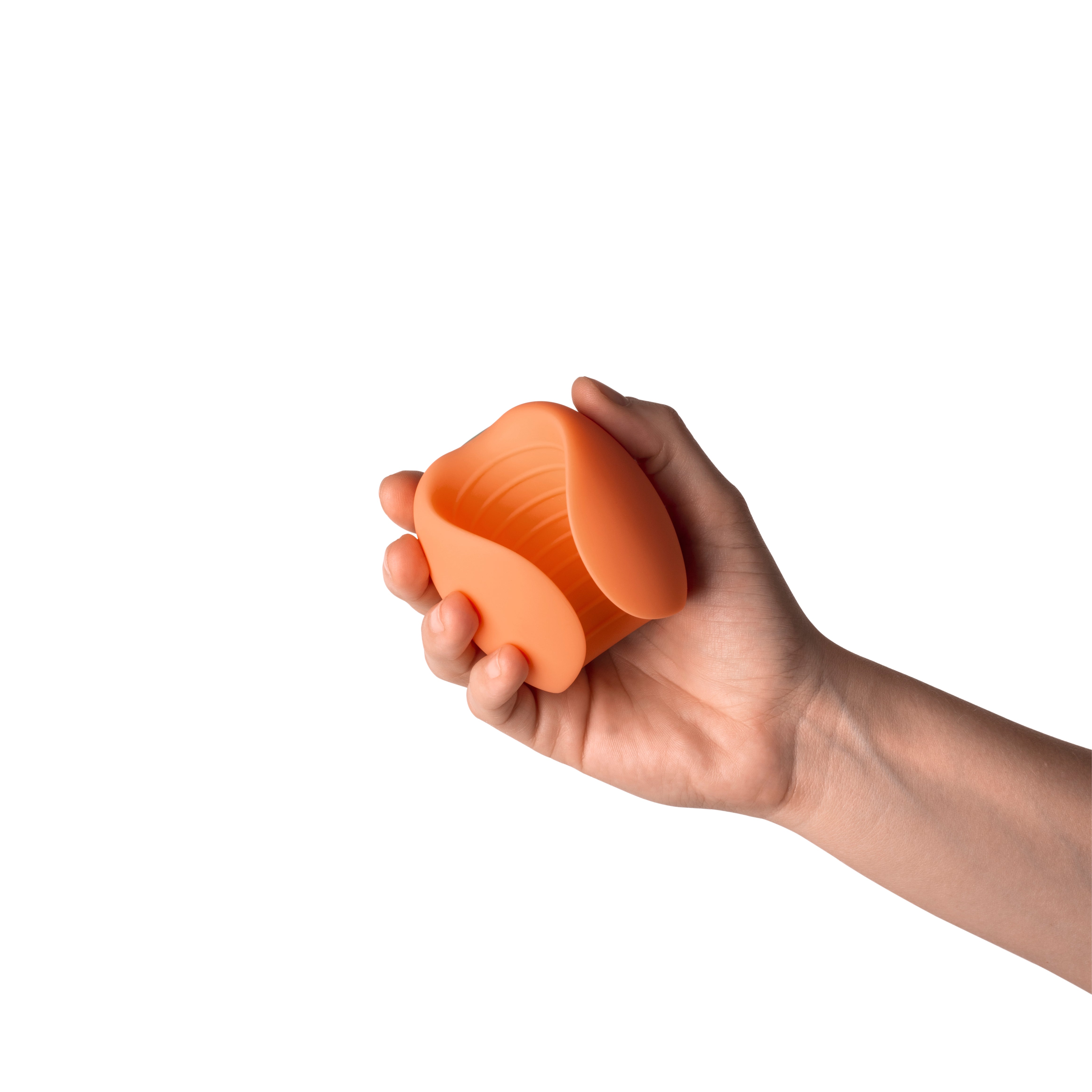 Hand holding a peach-colored silicone stroker with ribbed interior.