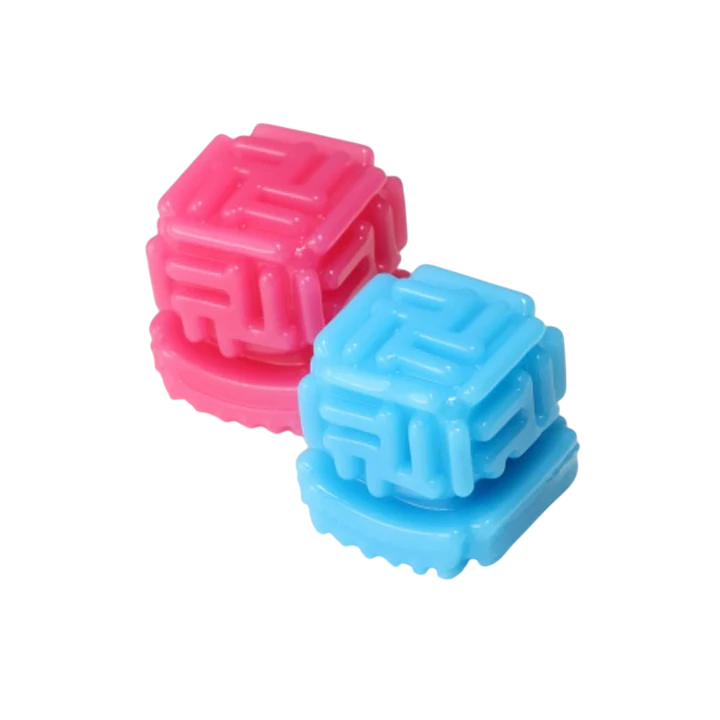 Two textured cube-shaped strokers, one pink and one blue, on a black background.