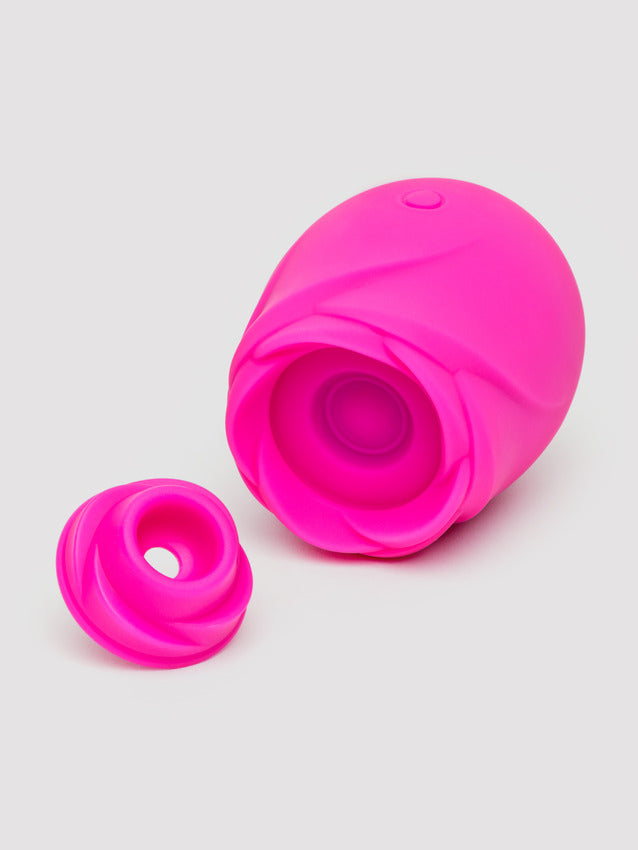 A bright pink rose-shaped clitoral stimulator with a separate textured cap.