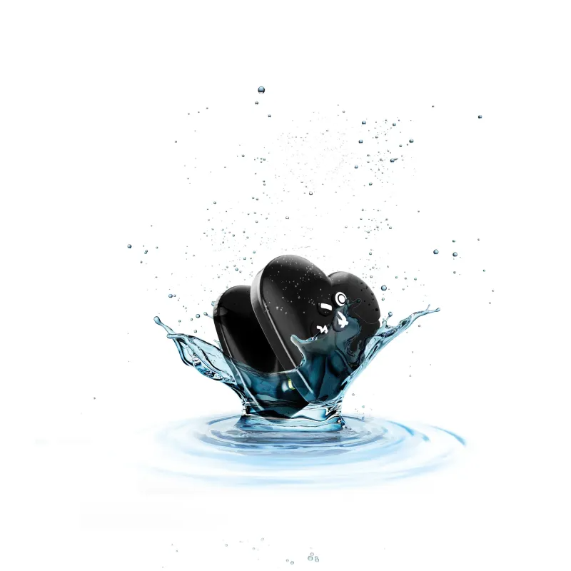 Two black heart-shaped vibrators submerged in water.