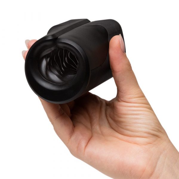 Black vibrating open sleeve masturbator held in a hand.
