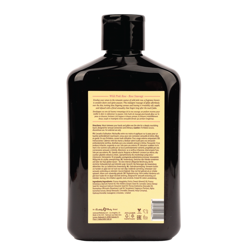 Wild Pink Rose massage oil in a dark bottle with product information.