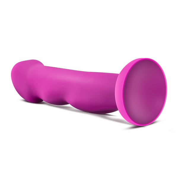 A purple silicone G-spot toy with a flared base and textured grip.