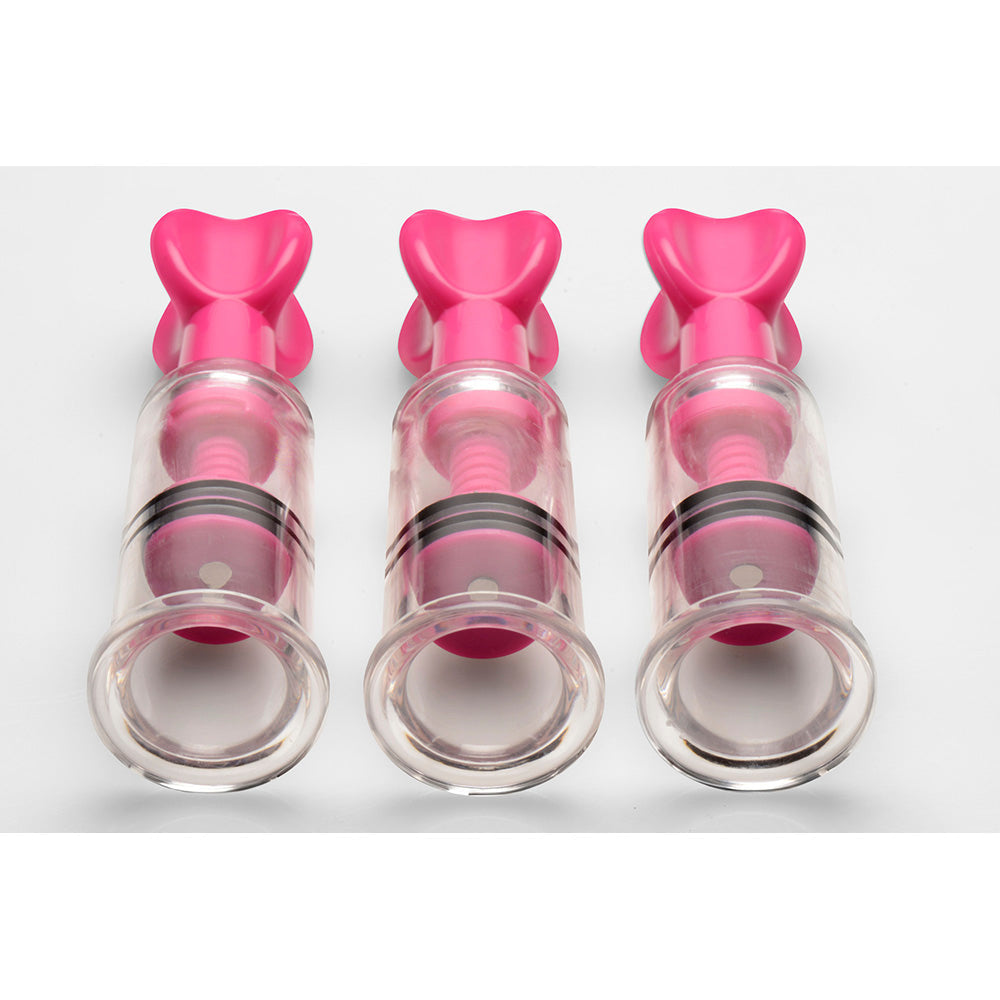 Three pink and clear nipple and clit suckers with black bands.