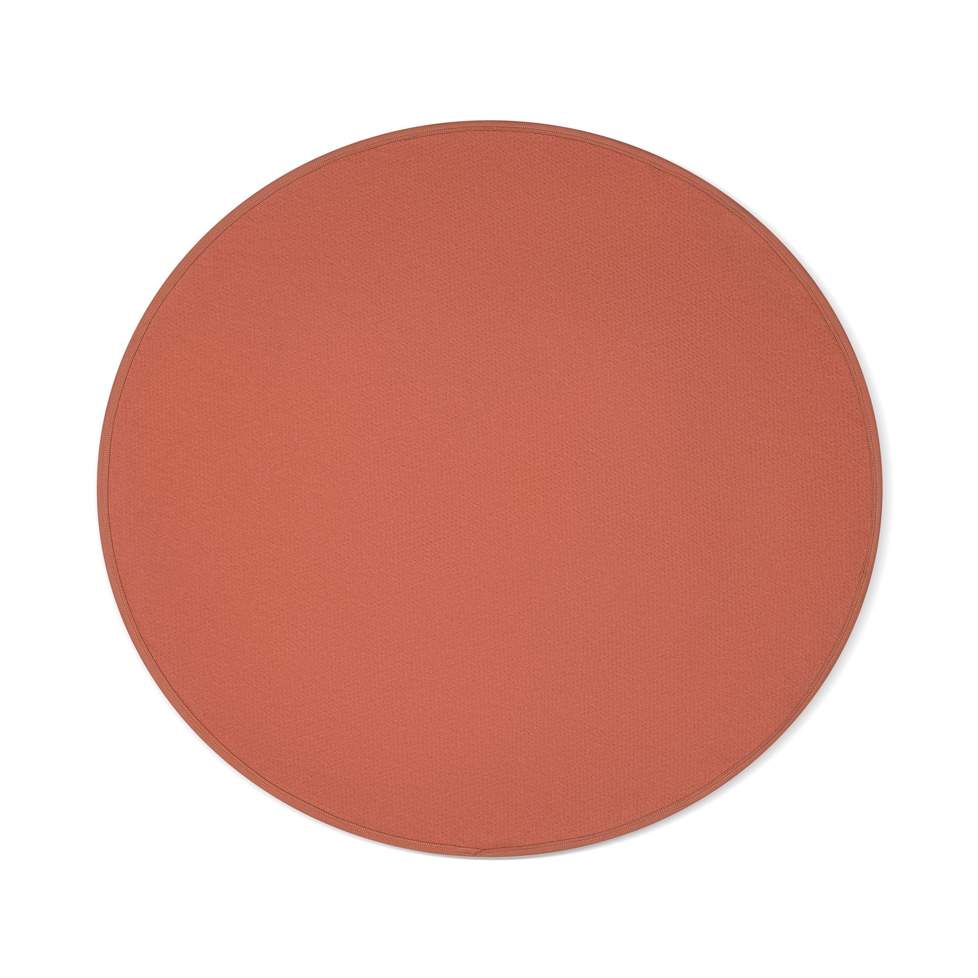 Circular copper waterproof blanket with textured surface.