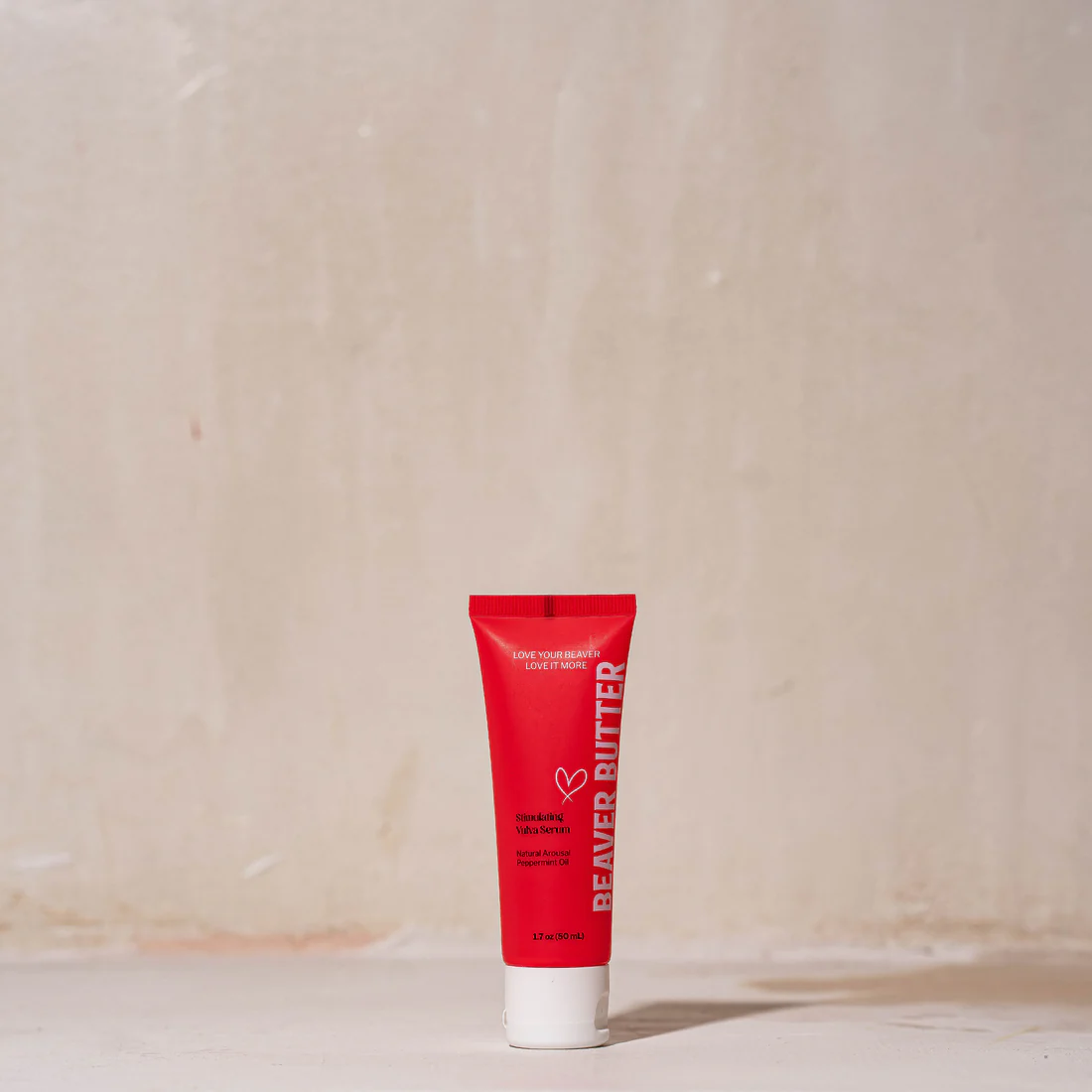 A red tube of Beaver Butter Stimulating Vulva Serum with white cap.