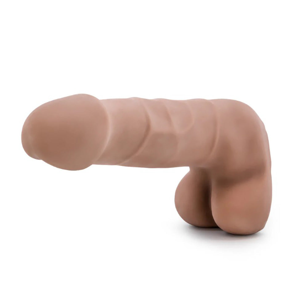 A 7-inch flexible dual-density dildo in blush color with realistic shaft and balls.