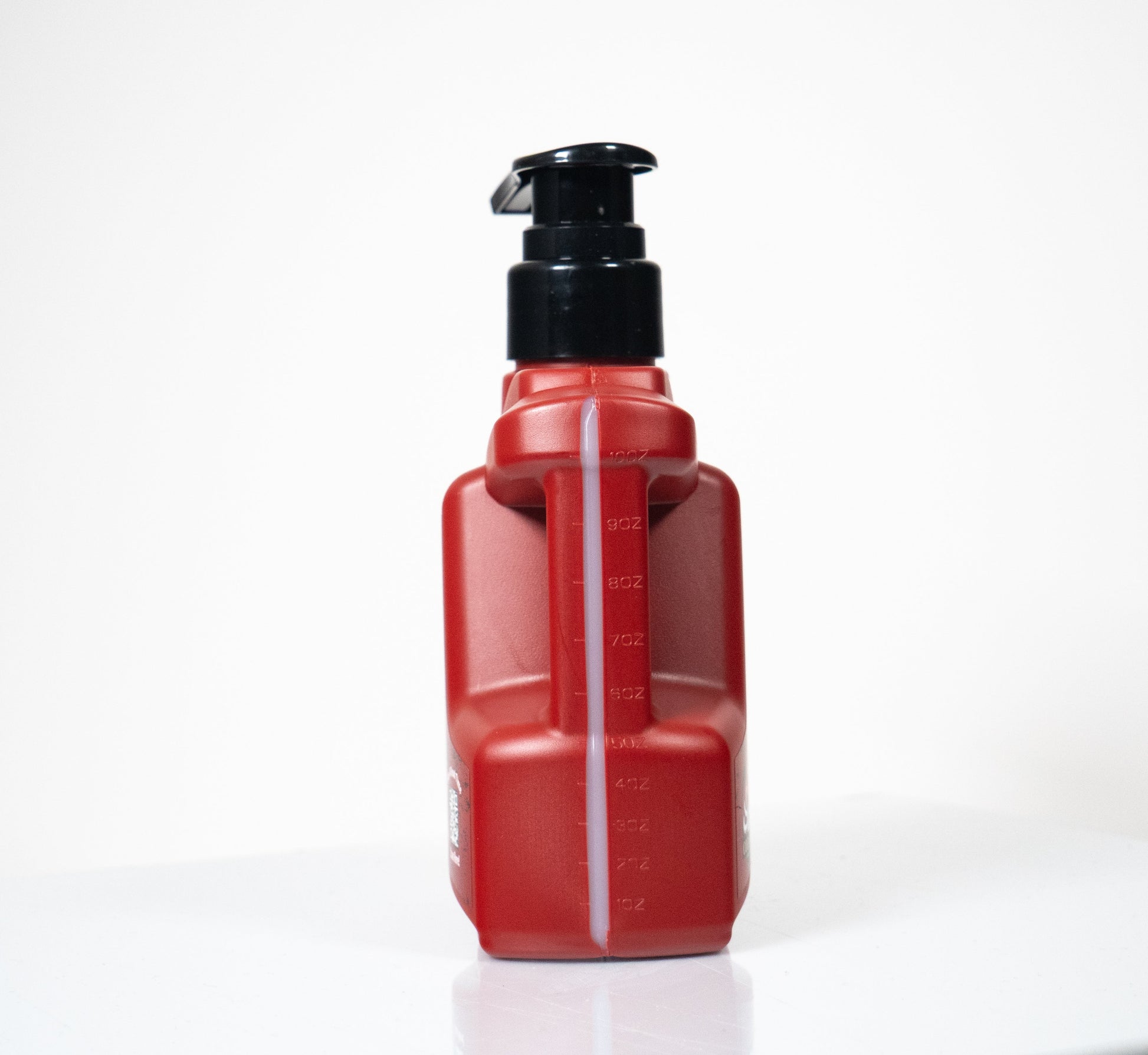 Red 10 oz water-based lubricant bottle with a black pump top and measurement markings.