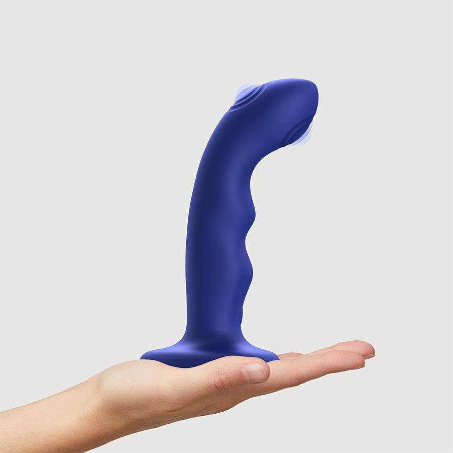 Blue silicone G-spot vibrator with a curved wave shape and double-tapping tip.