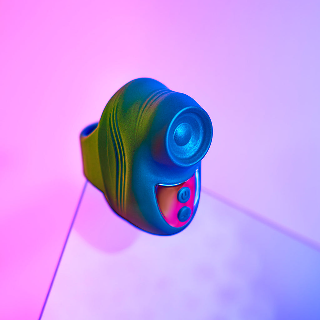 Iridescent teal finger vibrator with two pink buttons.